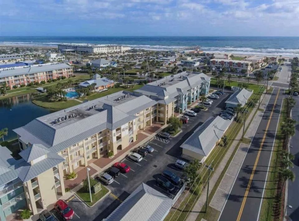 Ariel view...condo on 1st floor in yellow building.  Beach access is steps away!