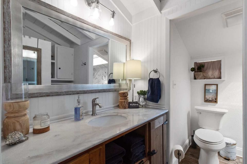 Bathroom with marble countertop & storage in the vanity