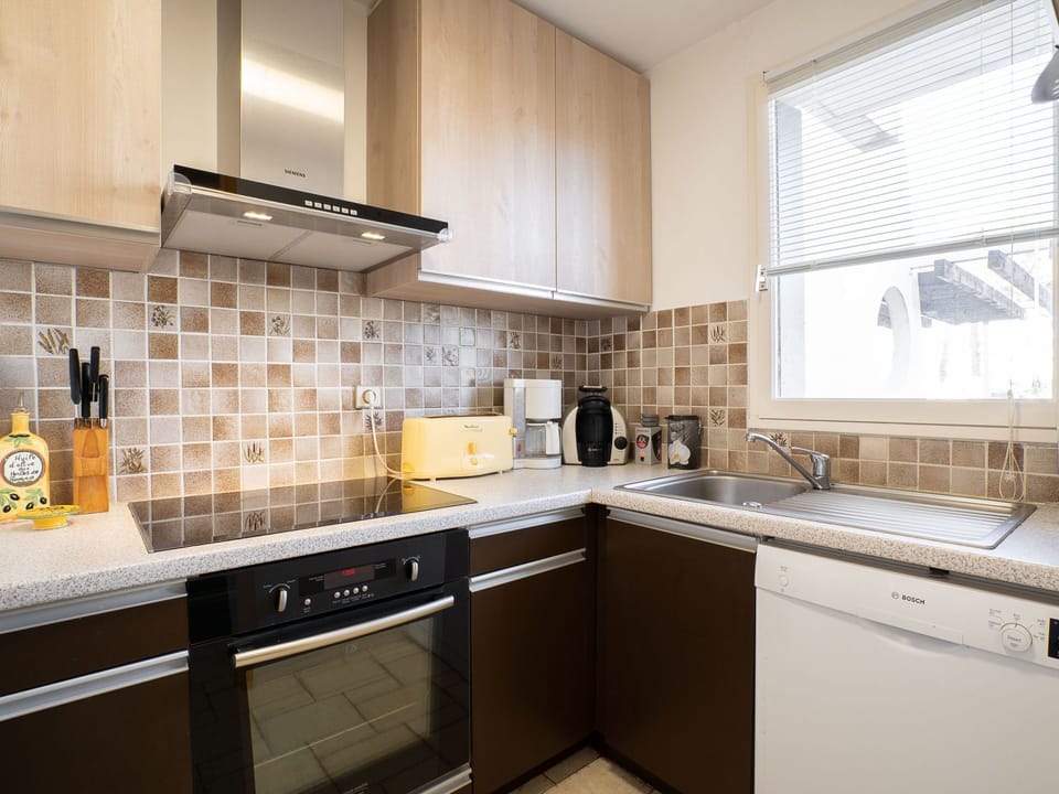 Countertop, Property, Room, Cabinetry, Kitchen, Tile, Furniture, Interior Design, Yellow, Building