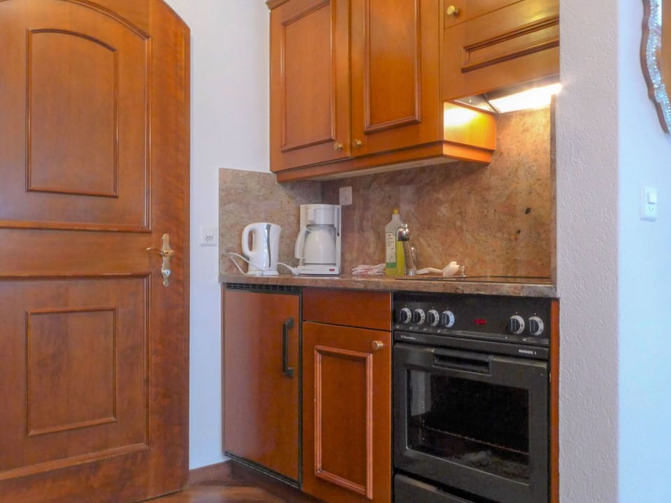 Cabinetry, Room, Kitchen, Furniture, Property, Countertop, Major Appliance, Wood Stain, Refrigerator, Cupboard