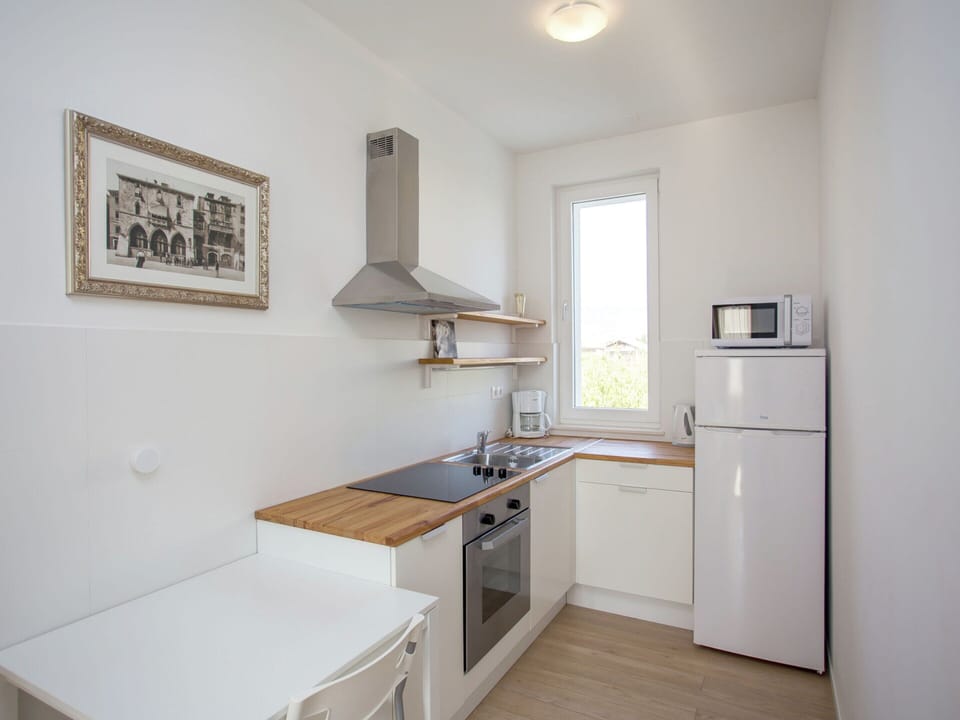 Villa | Private kitchen | Stovetop, coffee/tea maker, highchair, cookware/dishes/utensils