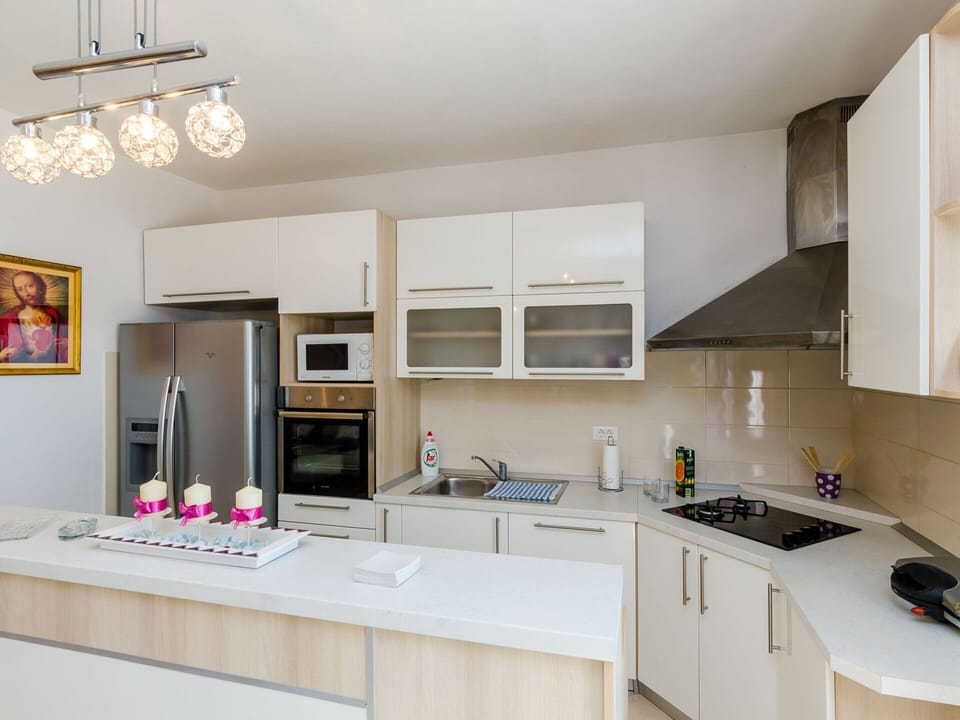 Villa | Private kitchen | Stovetop, highchair, cookware/dishes/utensils