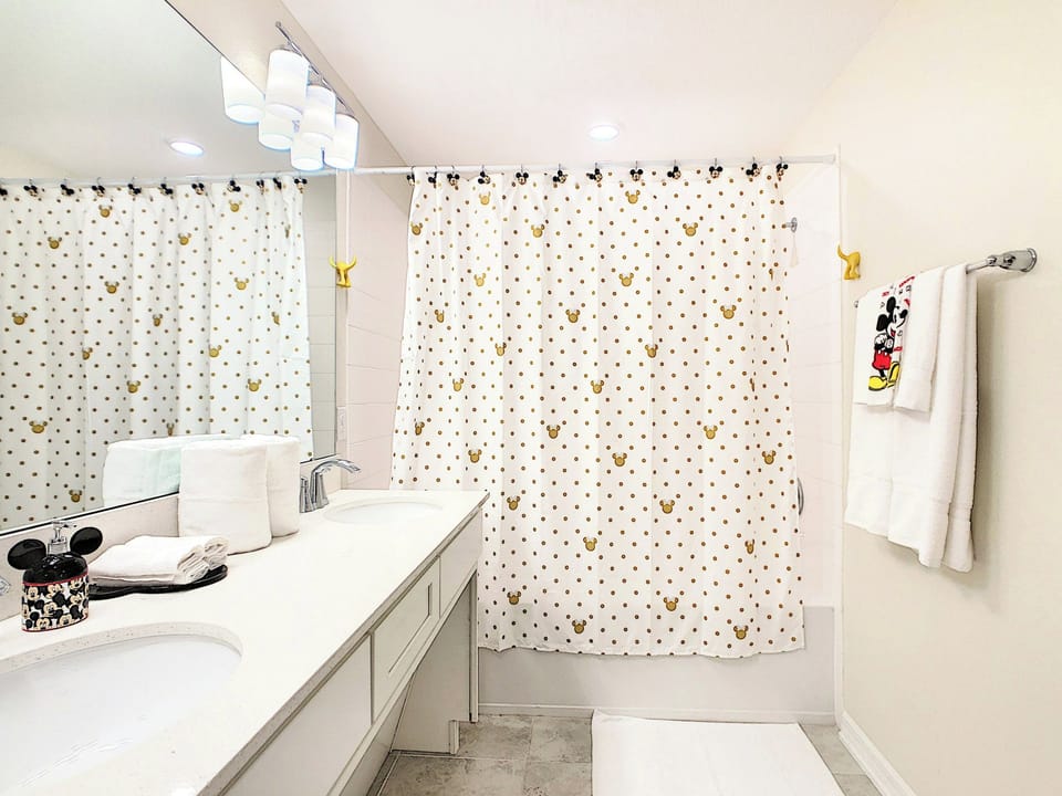 Disney-Themed Bathroom with Double Vanity and Tub