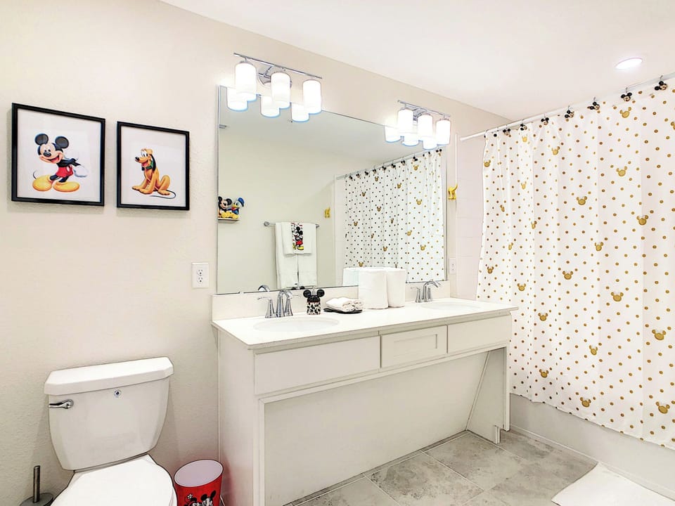 Bright Bathroom with Double Vanity and Themed Accents
