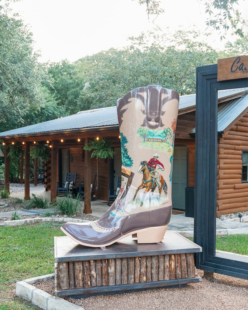 Hill Country character at Cabins on the Square — handcrafted Western yard art and curated details throughout the property.