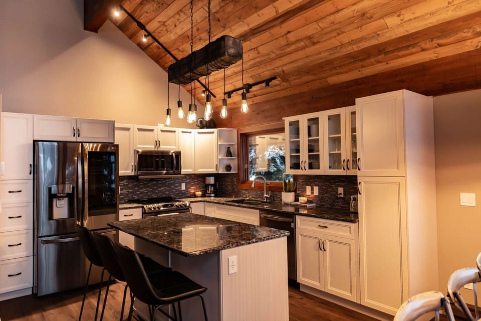 Modern Kitchen with large island, fridge, microwave, stove and much more.