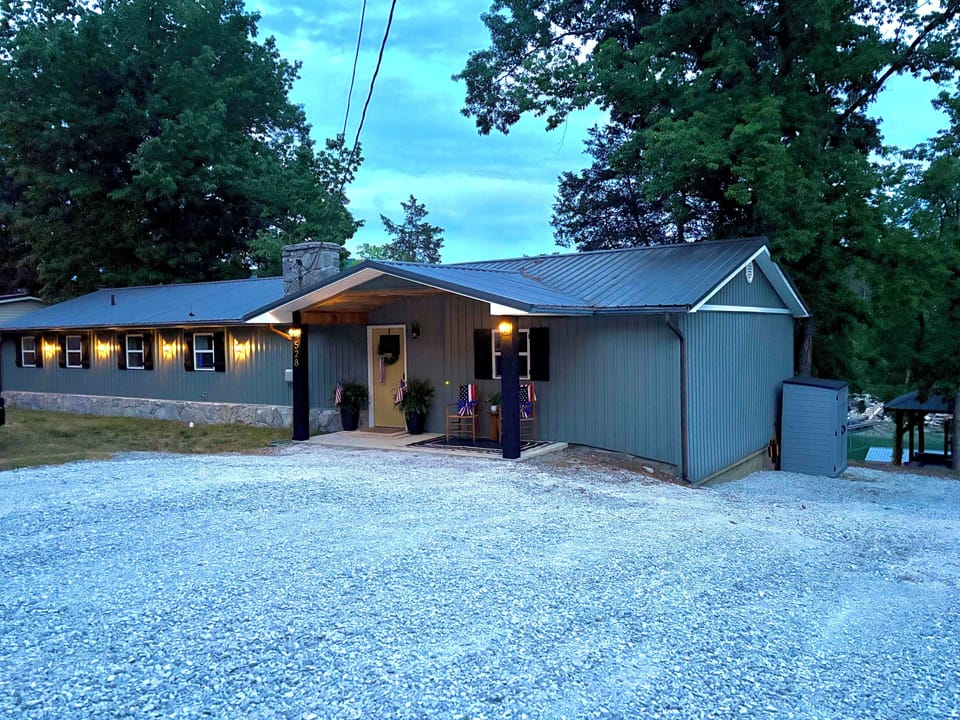  View of house and parking area from road