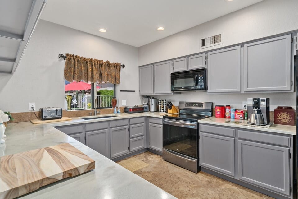 fully stocked kitchen with countertop appliances. 