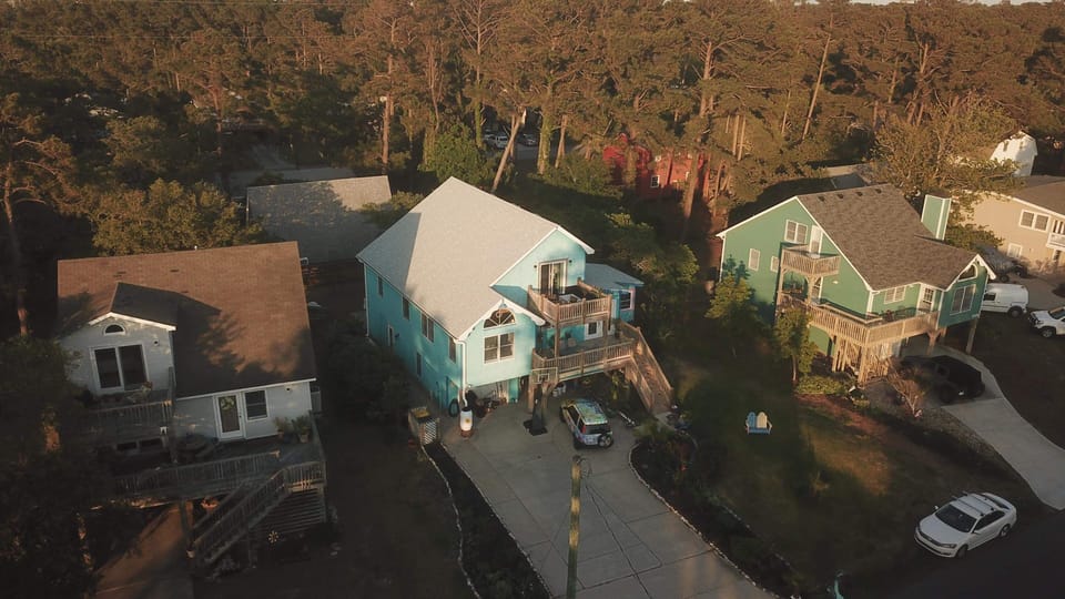 Blue center house.  The beach is .5 miles  behind the house.  