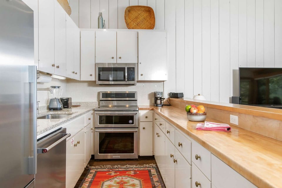 The fully equipped kitchen has lots of counter space and everything you need to prepare meals during your stay.