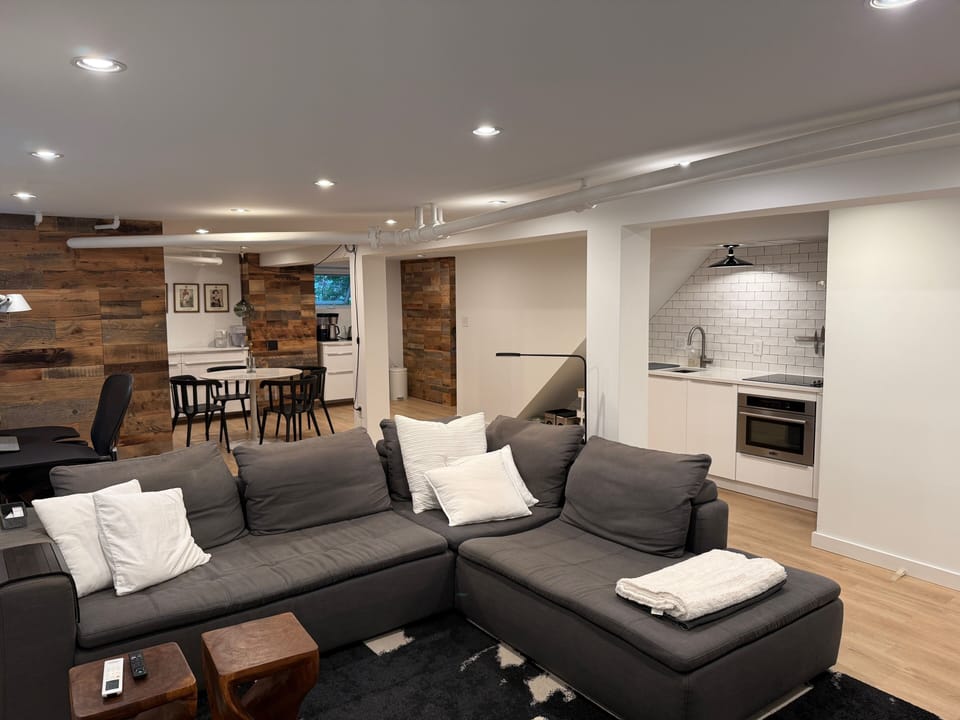 Open concept living with integrated kitchen, work station, dining area, lighting