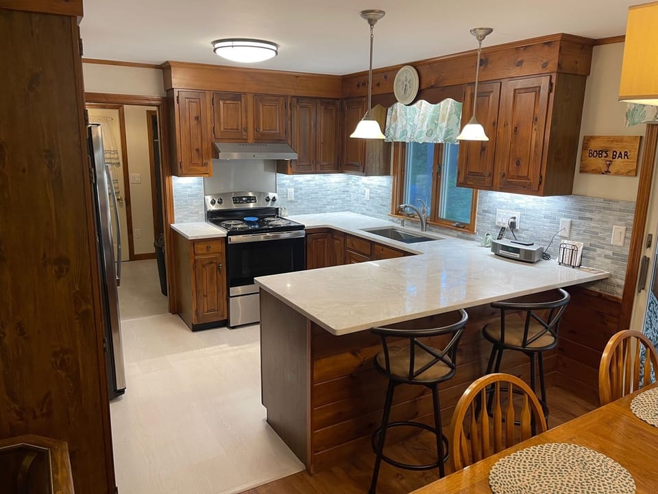 Kitchen with bar area next to the Dining area.