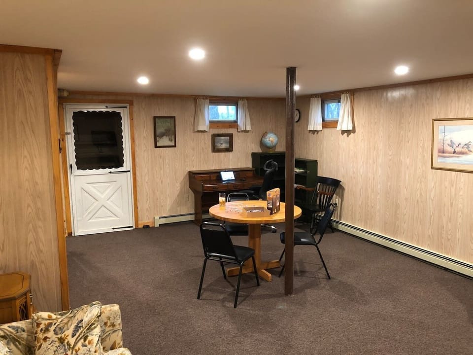 Large basement playroom for the kids with games, desk TV and a sofa bed. 