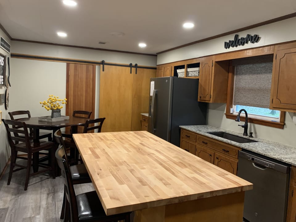 Deep sink, granite countertops & washer & dryer behind barn doors