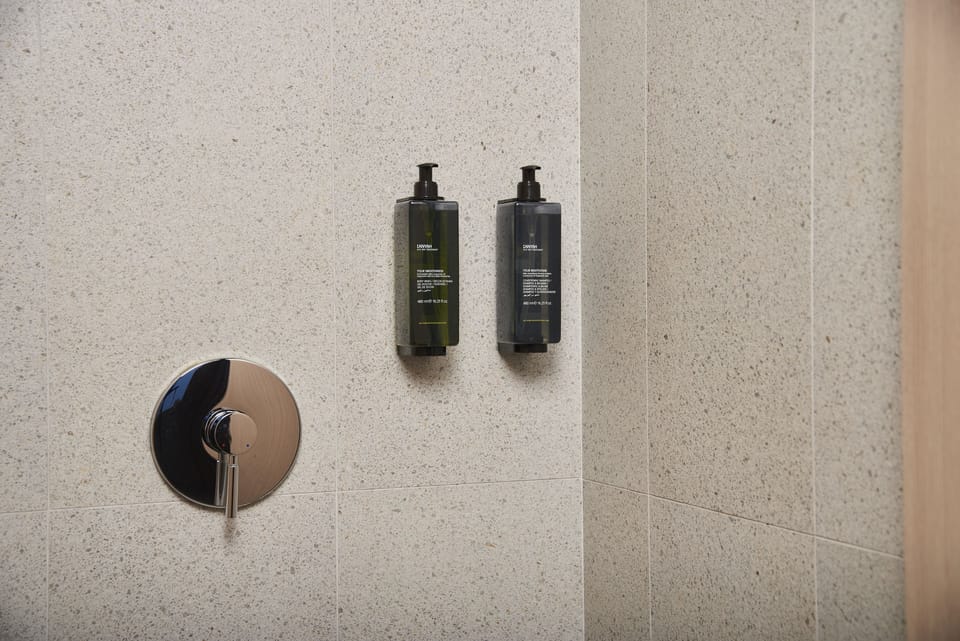 Shower, rainfall showerhead, hair dryer, towels
