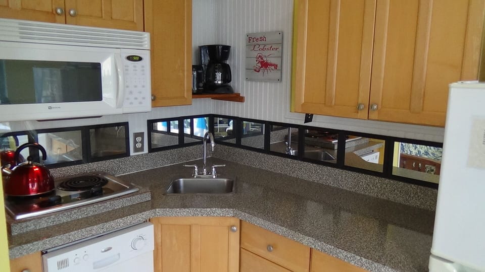 Plenty of counter, sink, two-burner stove, dishwasher, microwave, coffee pot