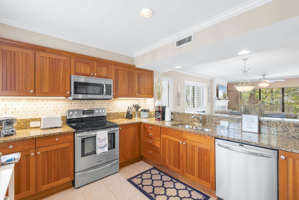 Kitchen has tile floors and plantation shutters. Professional waffle iron.