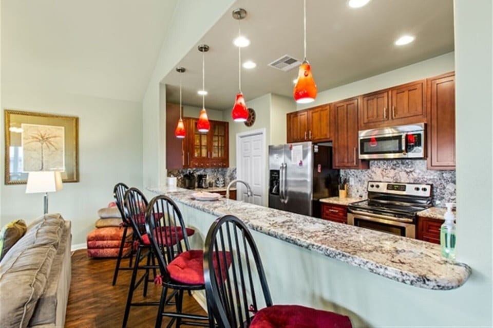 Open kitchen with breakfast bar, ideal for morning coffee and easy conversation.