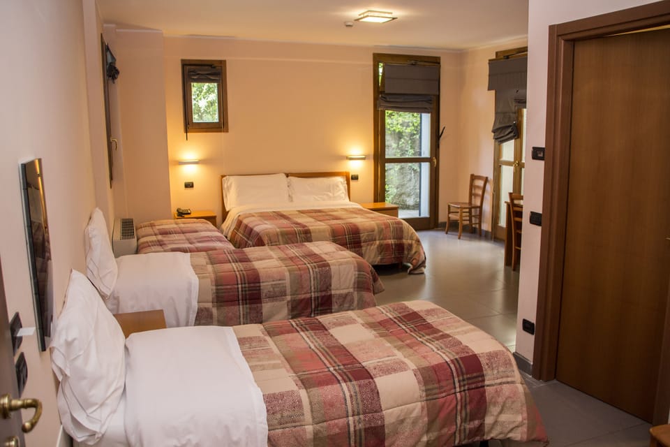 Quadruple Room | Minibar, in-room safe, individually furnished, desk