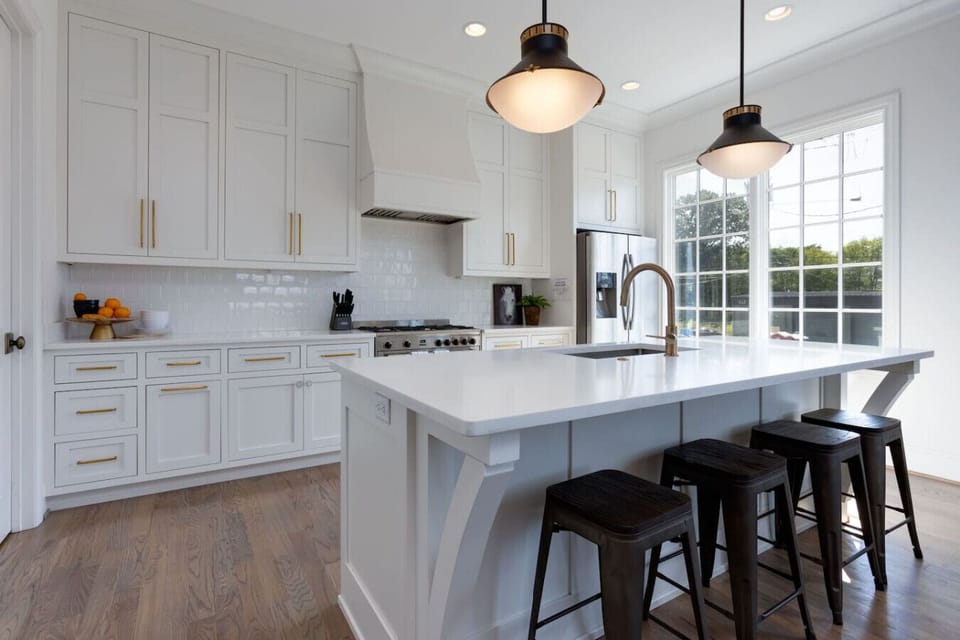 A spacious kitchen with a wide island, bar seating, and stainless appliances is ideal for group cooking.