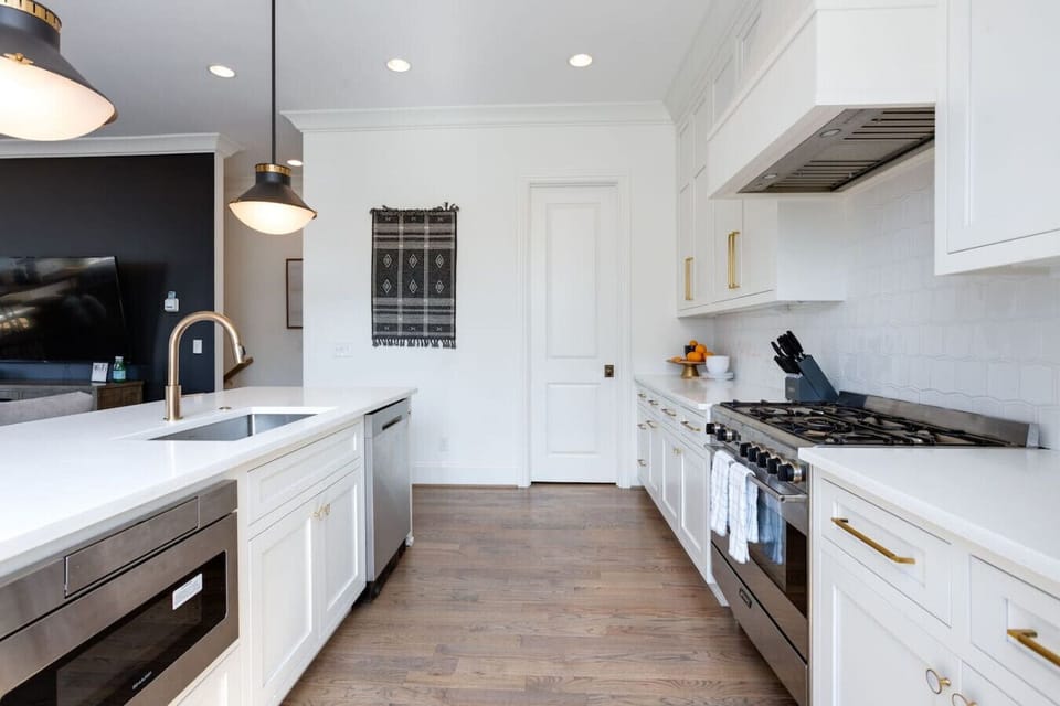 A modern kitchen with stainless steel appliances and ample prep space makes cooking here a pleasure.