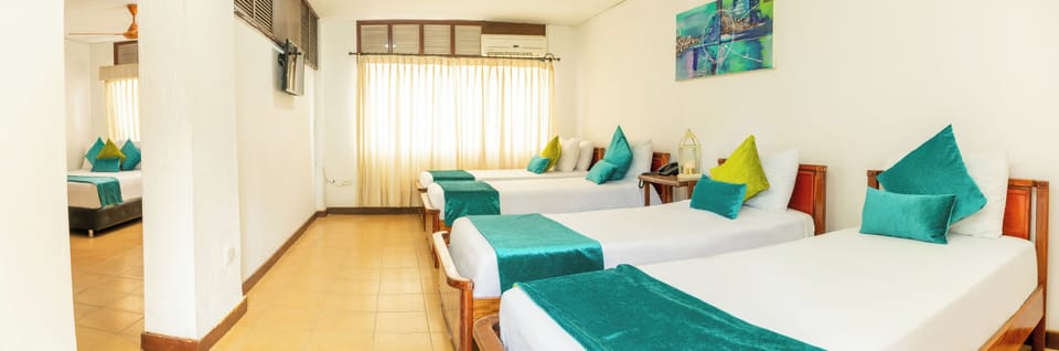 Family Room | Minibar, WiFi (free), bed sheets