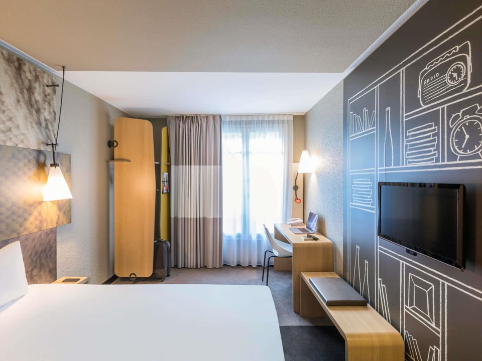 Hypo-allergenic bedding, desk, laptop workspace, blackout drapes