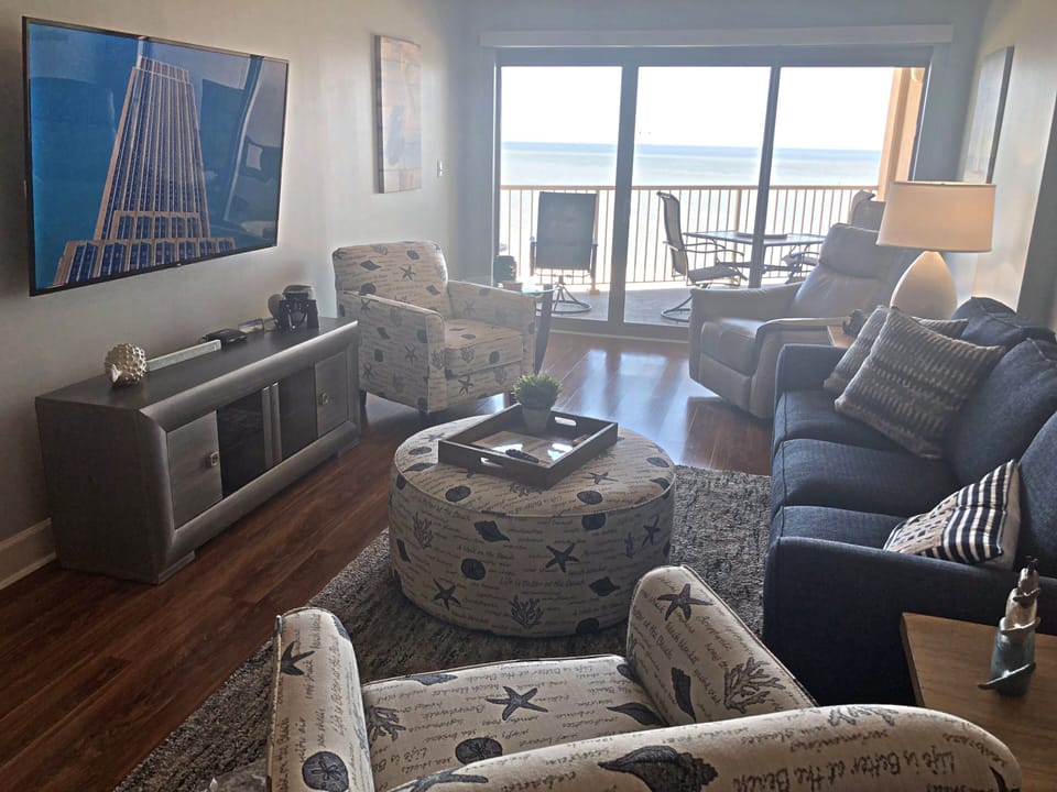 Our newly furnished living room with upscale furniture and a 65" smart TV.