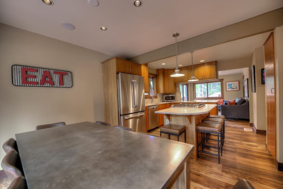Dining room table with seating for 8 and an additional 4 seats at the bar top
