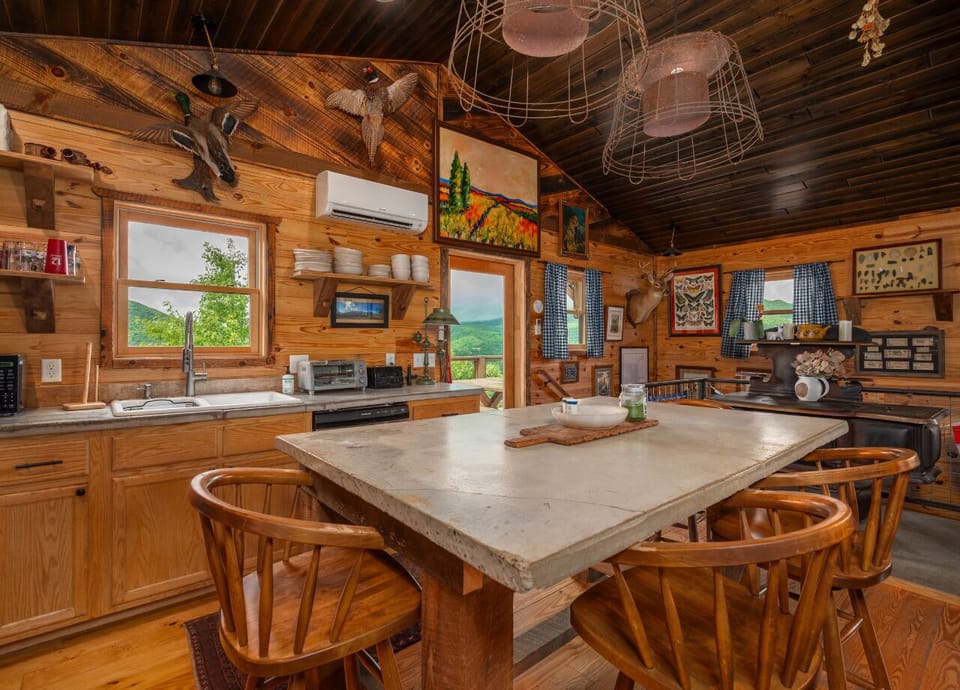 Kitchen with gas range, dishwasher, drip-style coffee maker, and island seating for 4 on the upper level.