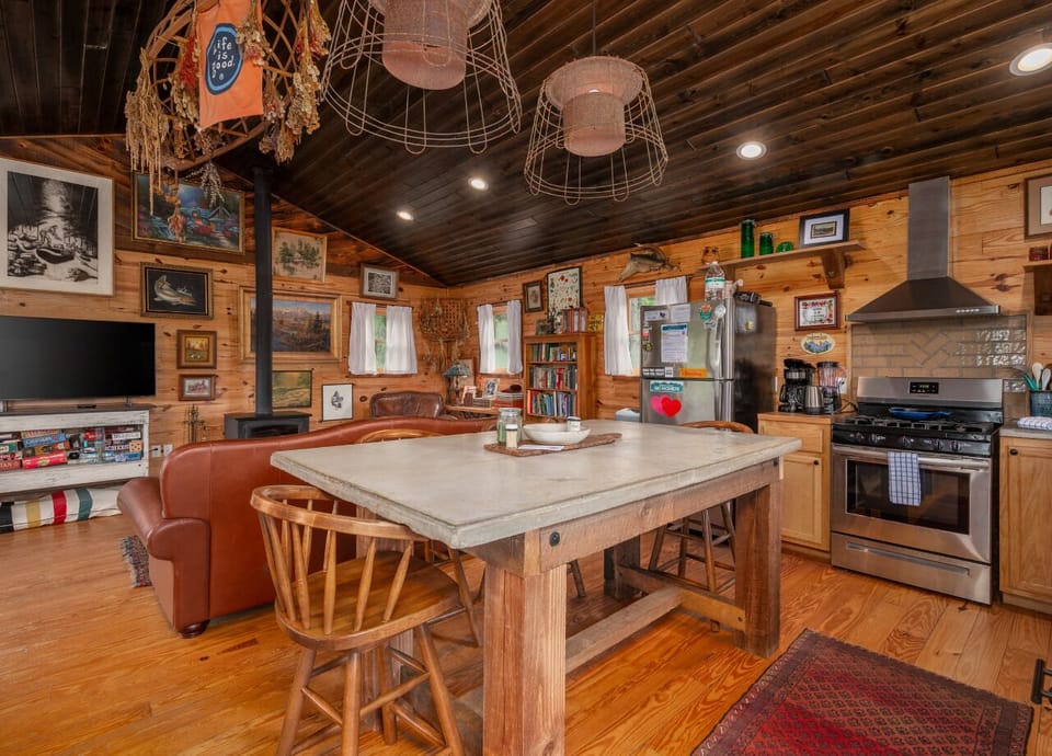 Kitchen with gas range, dishwasher, drip-style coffee maker, and island seating for 4 on the upper level.
