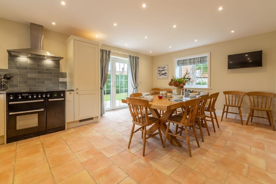 Ground floor: Well-equipped kitchen with double Belfast sink, electric range, combi microwave/ oven/ grill, fridge/freezer, dishwasher dining table (with seating for up to 12 guests) and french doors to the garden