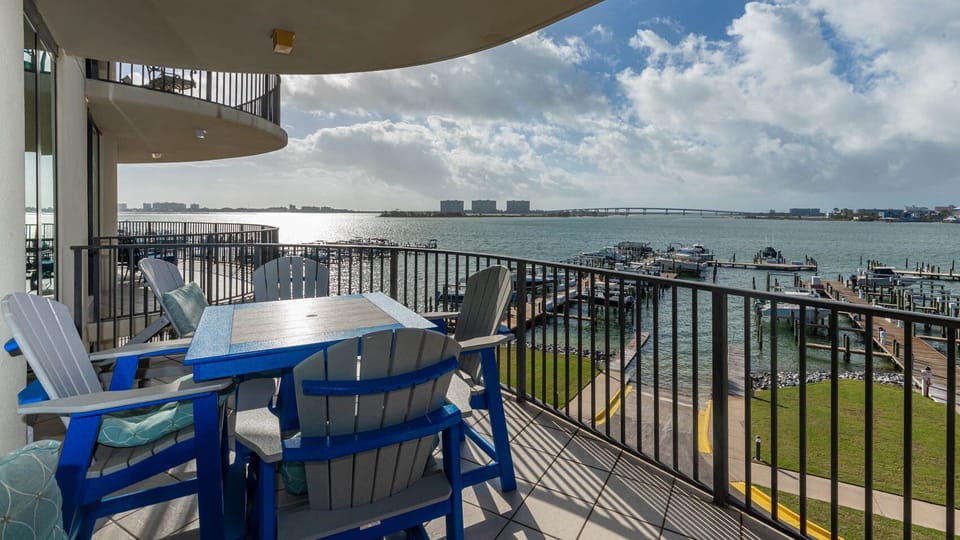 Savor the coastal breeze while relaxing at the stylish balcony table, with vibrant views of the marina on the bay