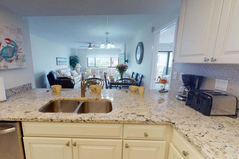 The kitchen is open to the living room with a dining table for 4 close by.