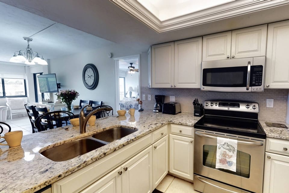 Newer updated kitchen with plenty of dishes, glasses and basic appliances.