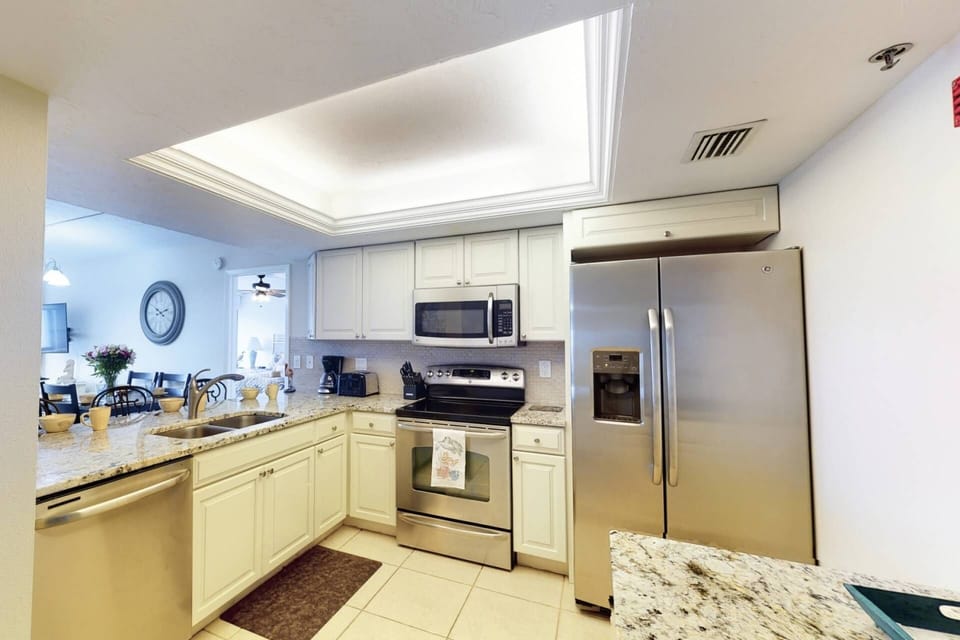 Spacious kitchen with new flooring, stainless appliances and plenty of granite counter area to prepare meals.