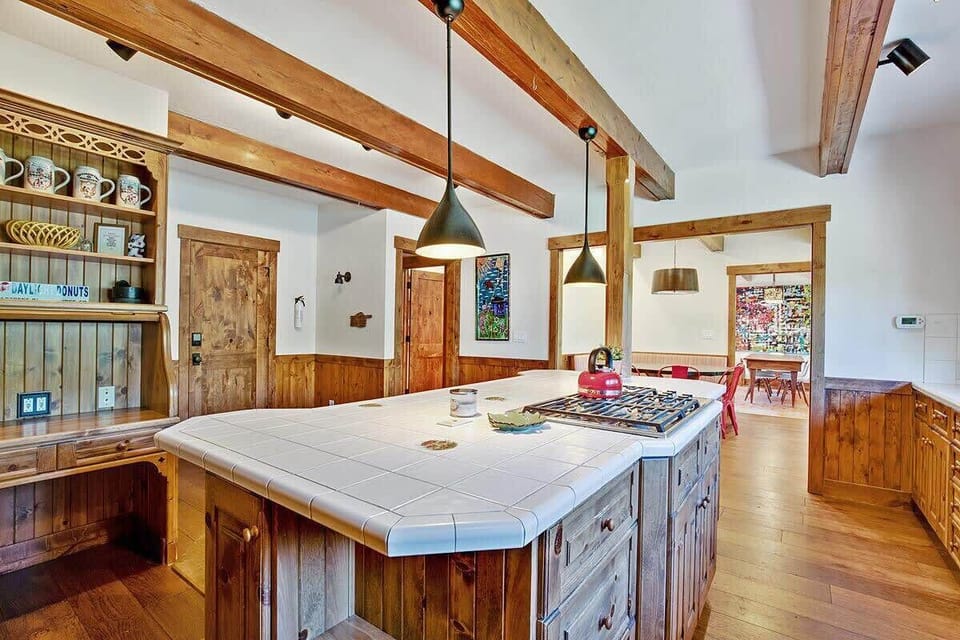 Fully stocked kitchen with large island and stainless steel appliances