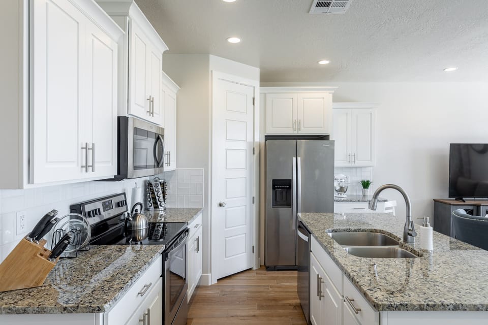 Kitchen - The kitchen is fully stocked with all the dishes, cookware, baking pans, and cutlery you will need for meal preparations and includes stainless steel appliances and granite counter tops.