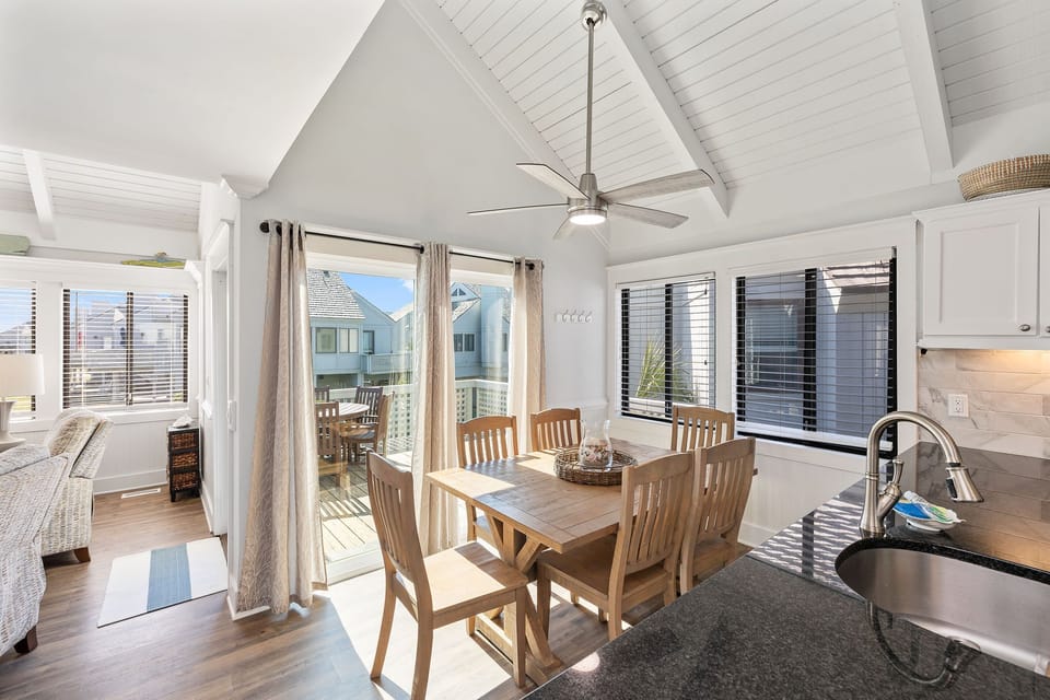 Dining area open to kitchen and living room with access to porch