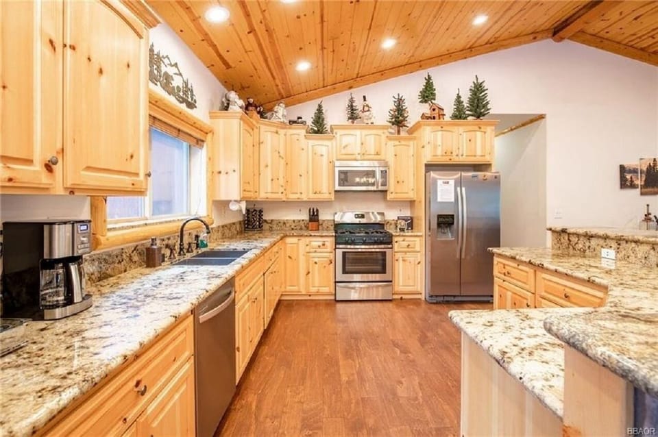 Natural wood cabinets and marble countertops.
