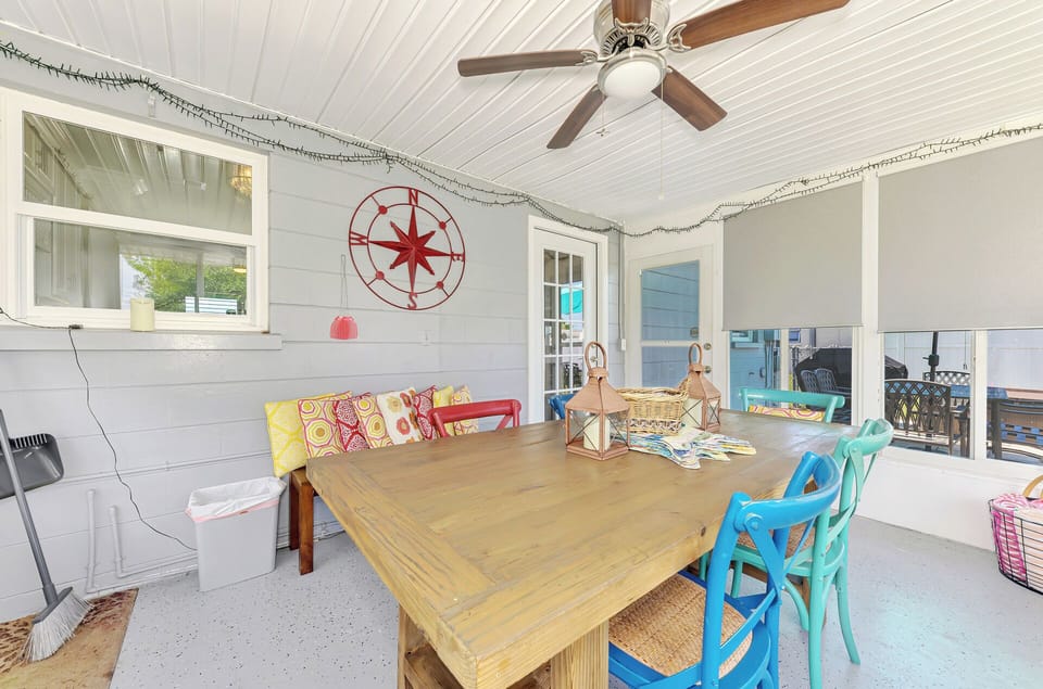 Back enclosed porch with ceiling fan and air conditioner. 