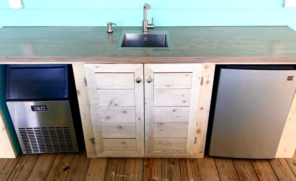 Sink, Fridge and Commercial Ice Maker on pool deck.