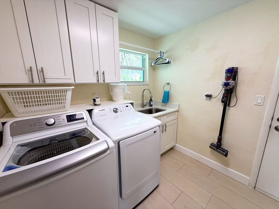 Laundry room with sink and Dyson vacuum