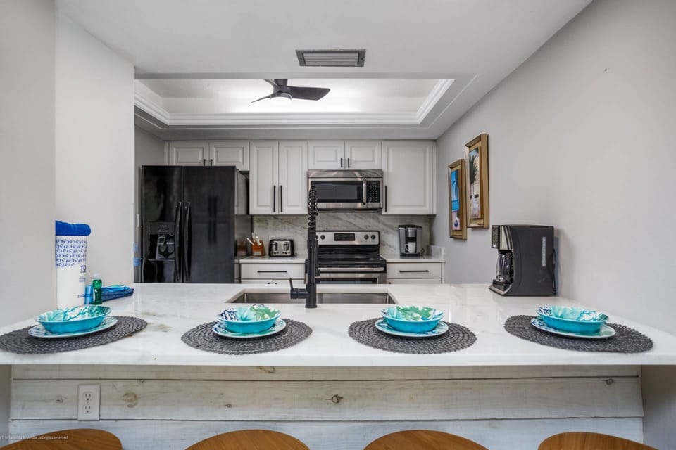 Newly painted & updated marble countertops with 4 kitchen counter seats