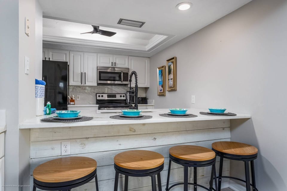 New marble kitchen countertop with seating for 4 people.  Enjoy your morning granola before heading to the private beach!