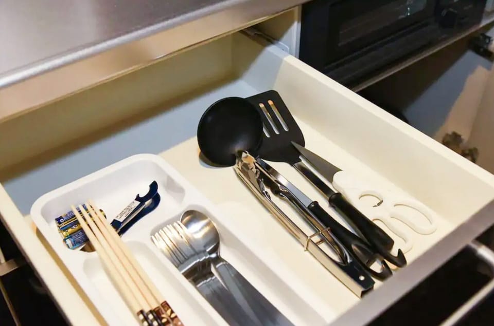 There are various cooking utensils in the drawer