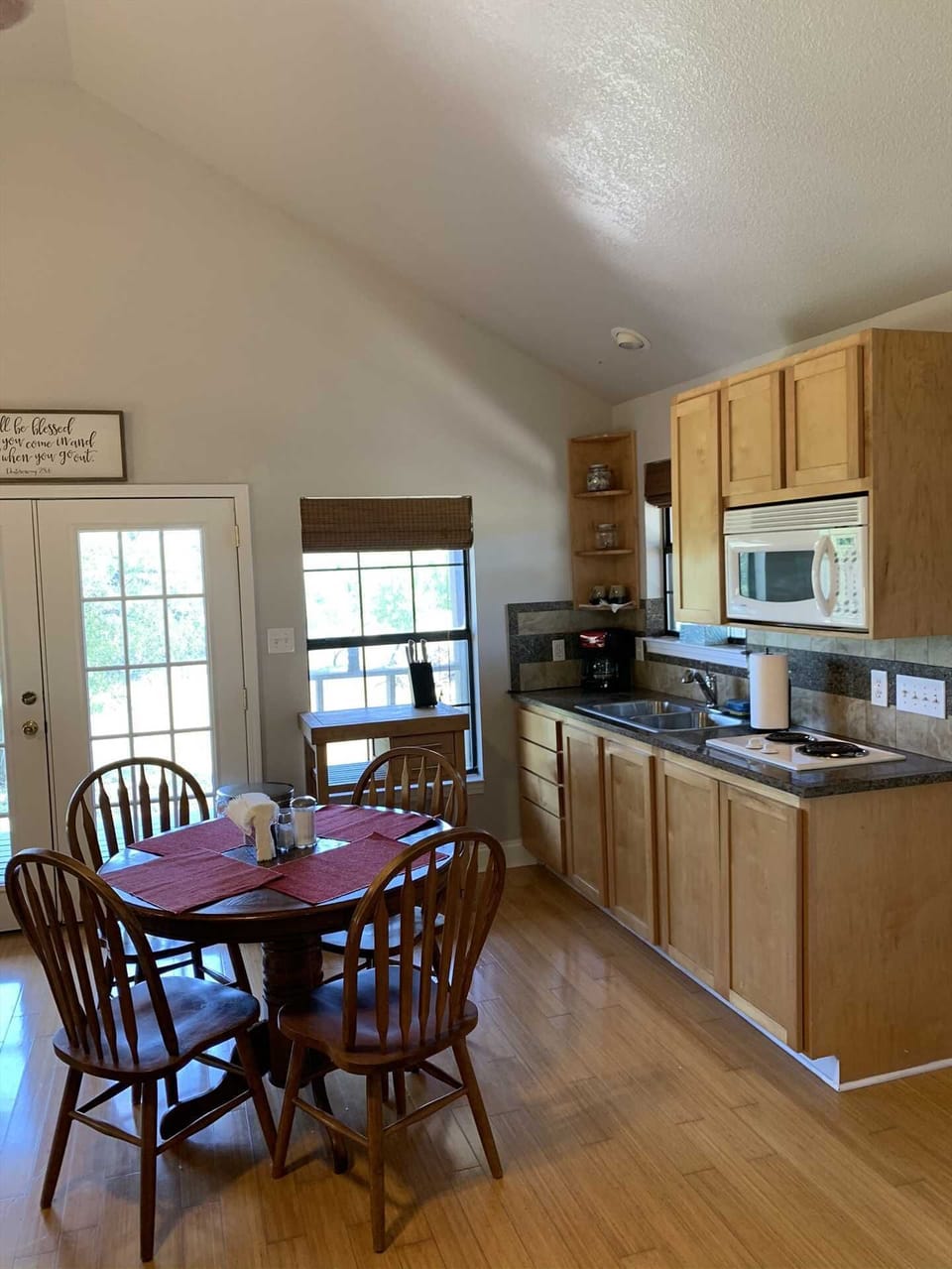 Blond wood furnishings and matching flooring create a comfortable and friendly space in the kitchen and dining room.