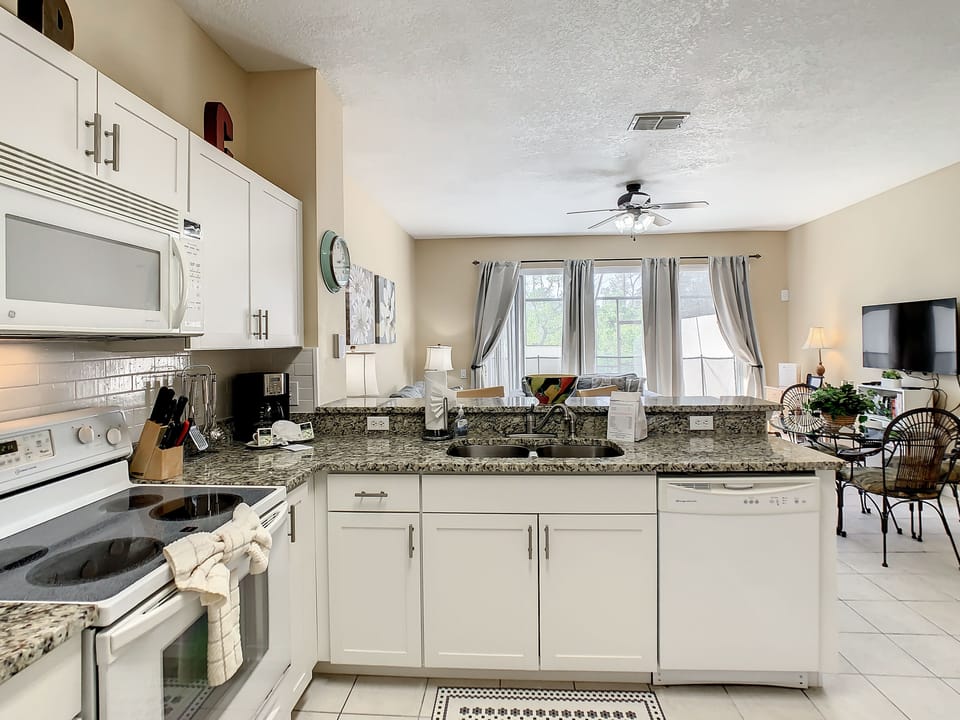 Fully equipped kitchen with stylish granite countertops and all essentials for cooking.