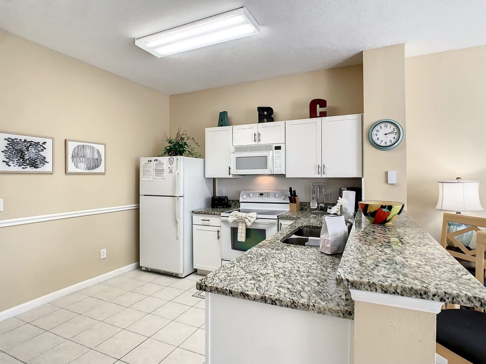 Spacious kitchen with modern appliances, ample counter space, and a bright dining area.