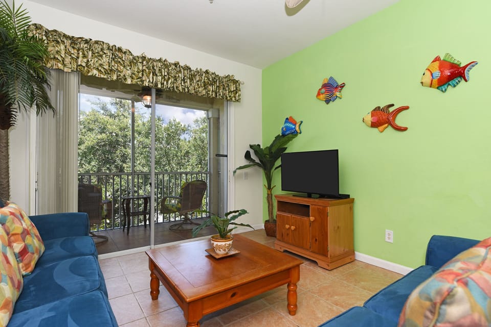 Cozy living room with natural light, comfy seating, and entertainment options for relaxing evenings.